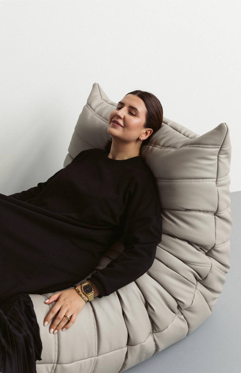 Black warm dress made of knitwear, decorated silk pleats